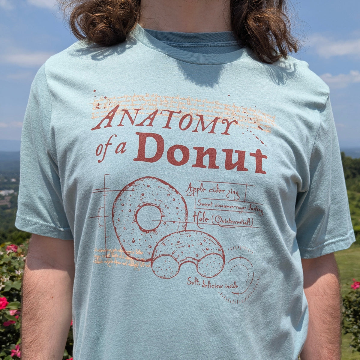 Man wearing a blue t-shirt with an Anatomy of a Donut graphic