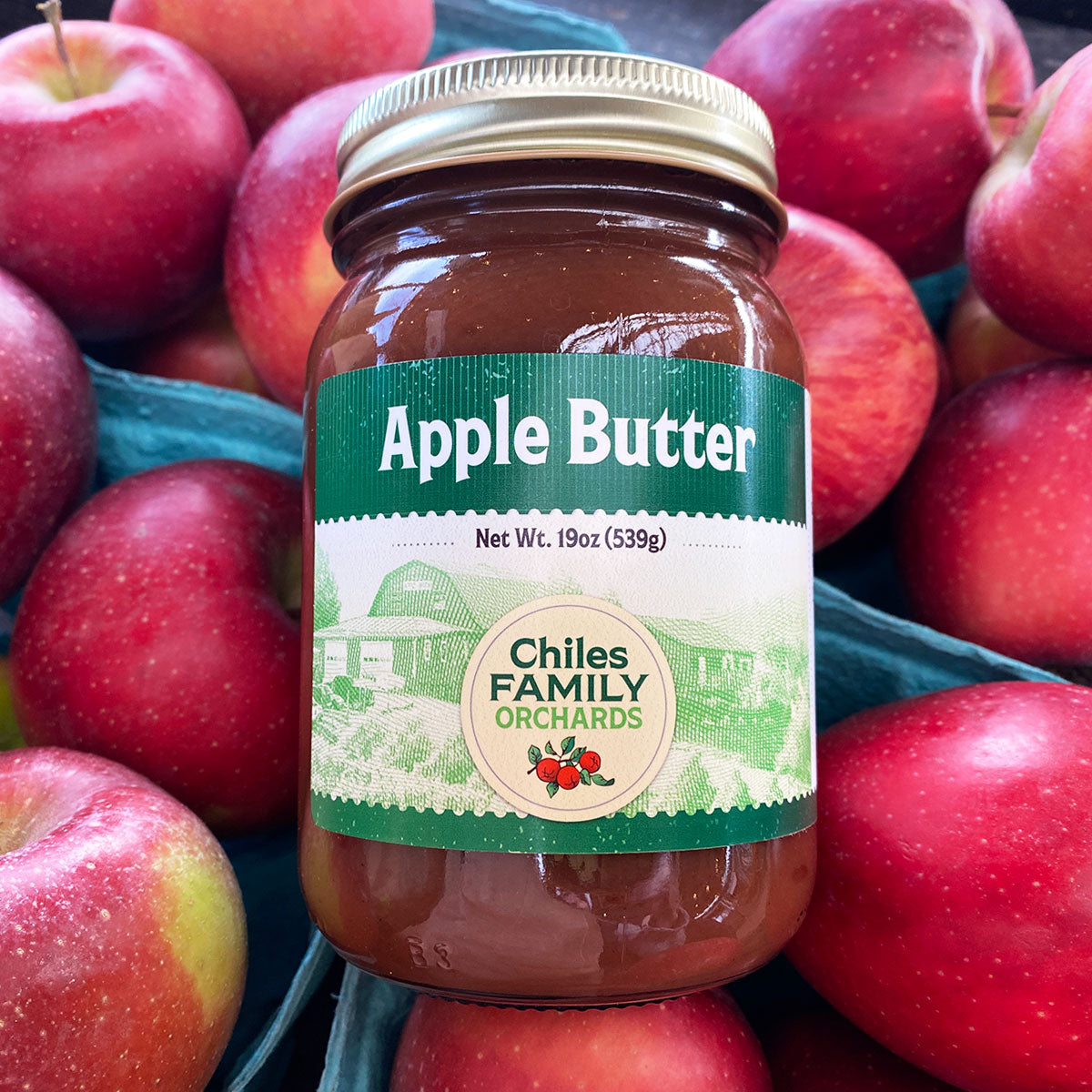 Apple butter jar on a bed of apples