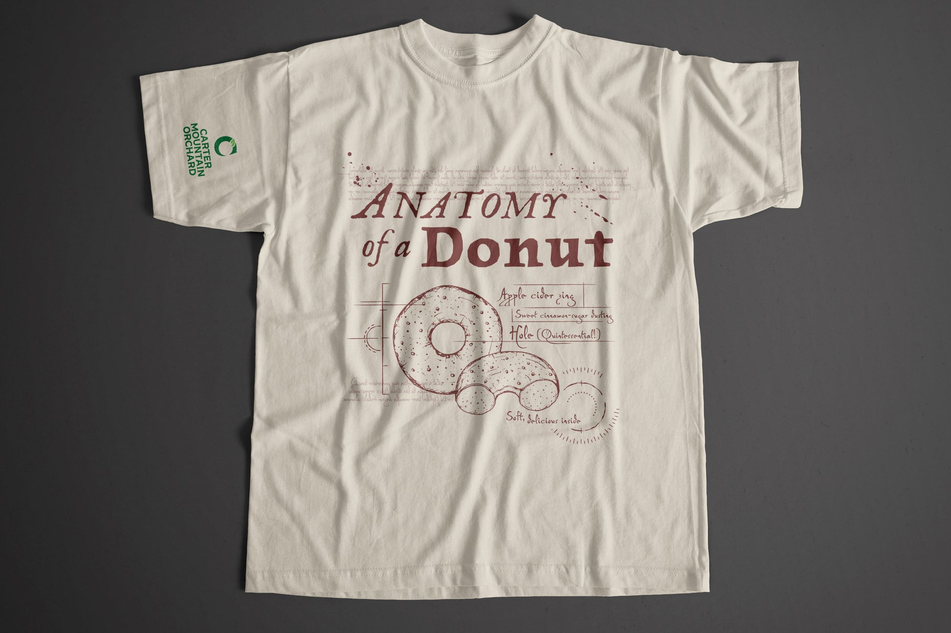 Beige t-shirt with 'Anatomy of a Donut' design on a gray background