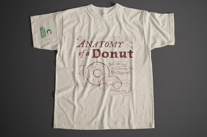 Beige t-shirt with 'Anatomy of a Donut' design on a gray background